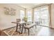 Bright dining area with modern table set and sliding door access to outdoor patio at 6311 Stable View St, Castle Pines, CO 80108