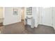 Bright foyer with hardwood floors, console table, stylish mirror, and white walls at 6311 Stable View St, Castle Pines, CO 80108