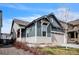Charming home with two-car garage, blue and beige siding, and well-kept landscaping at 6311 Stable View St, Castle Pines, CO 80108
