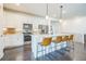 Modern kitchen with white cabinets, stainless steel appliances, and a large island with seating at 6311 Stable View St, Castle Pines, CO 80108
