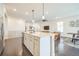 Open concept kitchen with an island, stainless steel appliances, and sleek finishes at 6311 Stable View St, Castle Pines, CO 80108