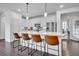 Stylish kitchen with white cabinets, stainless steel appliances, and an island with barstool seating at 6311 Stable View St, Castle Pines, CO 80108