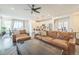 Spacious open-concept living area with hardwood floors, connecting kitchen, dining, and lounge spaces at 6311 Stable View St, Castle Pines, CO 80108