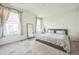 Serene main bedroom with a king-sized bed, large windows, and a full-length mirror, creating a peaceful retreat at 6311 Stable View St, Castle Pines, CO 80108