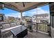 Covered deck with gas grill, lounge furniture, and views of the neighborhood at 6311 Stable View St, Castle Pines, CO 80108