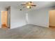 Spacious bedroom featuring neutral carpeting, a ceiling fan, and an ensuite bathroom for added convenience at 3855 S Monaco St # 177, Denver, CO 80237