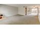 Spacious living room with neutral carpet, natural light, and convenient access to in-unit laundry and kitchen at 3855 S Monaco St # 177, Denver, CO 80237