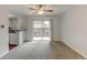 Inviting living space with a sliding door to a patio, ceiling fan, and open layout to the kitchen at 3855 S Monaco St # 177, Denver, CO 80237