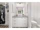 This bathroom has a gray countertop with white cabinets and modern lighting and is well-organized at 4408 E 107Th Pl, Thornton, CO 80233
