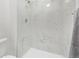 All-white bathroom features a shower with marble-like tiling and modern shower head fixture at 4408 E 107Th Pl, Thornton, CO 80233