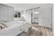 Comfortable bedroom featuring built-in storage, a cozy window seat, and access to the en-suite bathroom at 4408 E 107Th Pl, Thornton, CO 80233