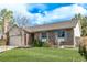 Well-kept brick home with a lush green lawn, blue shutters and a two car garage at 4408 E 107Th Pl, Thornton, CO 80233