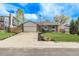 Traditional home with a brick facade, two-car garage, and vibrant landscaping at 4408 E 107Th Pl, Thornton, CO 80233
