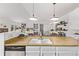 Stylish kitchen with butcher block counters and stainless steel appliances adjacent to the living area at 4408 E 107Th Pl, Thornton, CO 80233
