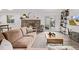 Bright and airy living room with modern decor, shelving and fireplace at 4408 E 107Th Pl, Thornton, CO 80233