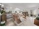 Bright and airy living room with wood floors, open concept to the kitchen, fireplace, and skylights at 4408 E 107Th Pl, Thornton, CO 80233