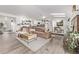 Open living room features a plush couch, light wood floors and a modern decor with plenty of natural light at 4408 E 107Th Pl, Thornton, CO 80233