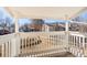 View from balcony with white wooden railings overlooking the lawn and surrounding buildings on a sunny day at 14182 E Colorado Dr # 204, Aurora, CO 80012