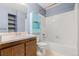 Standard bathroom with combination tub and shower, vanity with storage, and shelves next to the mirror at 14182 E Colorado Dr # 204, Aurora, CO 80012