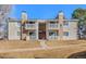 Inviting condo exterior featuring stone accents, balconies and well-maintained landscaping at 14182 E Colorado Dr # 204, Aurora, CO 80012