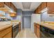 Functional kitchen featuring essential appliances and ample wood cabinets at 14182 E Colorado Dr # 204, Aurora, CO 80012