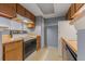 Compact kitchen features wood cabinets and essential appliances at 14182 E Colorado Dr # 204, Aurora, CO 80012