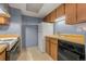 Efficient kitchen with appliances, tile flooring, and neutral finishes at 14182 E Colorado Dr # 204, Aurora, CO 80012