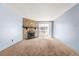 Bright living room featuring a cozy fireplace and sliding glass doors to the balcony at 14182 E Colorado Dr # 204, Aurora, CO 80012