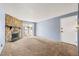 Spacious living room with a stone fireplace and sliding doors to a balcony at 14182 E Colorado Dr # 204, Aurora, CO 80012