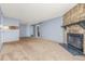Open-concept layout featuring fireplace, neutral carpet, and access to other rooms at 14182 E Colorado Dr # 204, Aurora, CO 80012