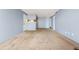 Bright living room flows into a kitchen featuring a breakfast bar with carpet flooring at 14182 E Colorado Dr # 204, Aurora, CO 80012