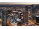 Nighttime aerial view of Denver's lit-up skyscrapers, buildings, and streets with mountains in distance at 1020 15Th St # 9K, Denver, CO 80202