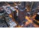 Aerial view of brown apartment building and nearby streets and buildings at nighttime at 1020 15Th St # 9K, Denver, CO 80202