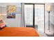 Serene bedroom boasts a balcony, city views, and a modern mountainscape wall art at 1020 15Th St # 9K, Denver, CO 80202