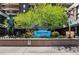 Lush, green landscaping surrounds the Brooks Tower building sign and statue at 1020 15Th St # 9K, Denver, CO 80202