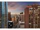 View from tall building of city buildings at sunset, including tower building with balconies at 1020 15Th St # 9K, Denver, CO 80202
