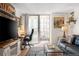Open-concept living room with a balcony, workspace, and comfortable seating area at 1020 15Th St # 9K, Denver, CO 80202