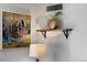 Elegant living room detail with a stylish shelf, artwork, and a decorative lamp at 1020 15Th St # 9K, Denver, CO 80202