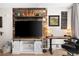Cozy living room boasting a reclaimed wood accent wall and a white entertainment center at 1020 15Th St # 9K, Denver, CO 80202