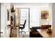 Bright living room with a balcony and a designated workspace featuring city views at 1020 15Th St # 9K, Denver, CO 80202