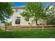 Backyard featuring a wood fence, mature tree, and green grass at 10696 Riverbrook Cir, Highlands Ranch, CO 80126