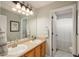 Bathroom with double sinks, a large mirror, and bright lighting at 10696 Riverbrook Cir, Highlands Ranch, CO 80126