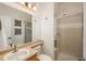 Well-lit bathroom featuring a glass-enclosed shower, a sink with tan countertops, and decor at 10696 Riverbrook Cir, Highlands Ranch, CO 80126