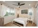 Cozy bedroom featuring a double bed, side tables, and large windows for natural light at 10696 Riverbrook Cir, Highlands Ranch, CO 80126