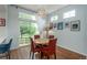 Bright dining room with sliding glass doors offering backyard view, and a modern chandelier at 10696 Riverbrook Cir, Highlands Ranch, CO 80126