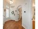 Bright entryway featuring hardwood floors, white door with a wreath, and an arched doorway at 10696 Riverbrook Cir, Highlands Ranch, CO 80126