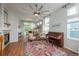 Bright living room featuring a high ceiling with large fan, a piano, and large windows with backyard view at 10696 Riverbrook Cir, Highlands Ranch, CO 80126