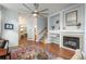 Cozy living room with fireplace, open archways, and hardwood floors at 10696 Riverbrook Cir, Highlands Ranch, CO 80126