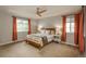 Serene main bedroom with a ceiling fan, large windows, and a bed with white bedding at 10696 Riverbrook Cir, Highlands Ranch, CO 80126
