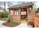 Charming outdoor space with a shed featuring wooden accents, an outdoor dining table, and potted plants at 3719 W 30Th Ave, Denver, CO 80211